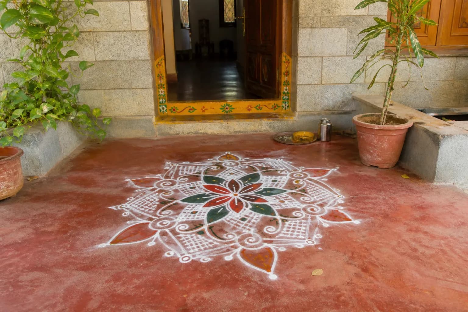A rangoli drawn in rice flour at a doorstep